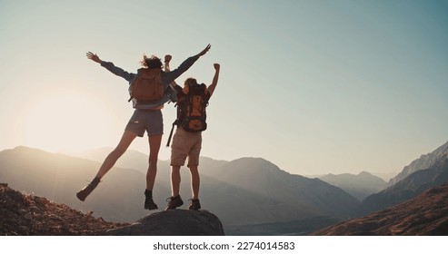 Travel concept with happy couple at mountain top with raised arms and islands at background. Place for text.  - Shutterstock ID 2274014583
