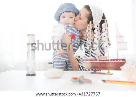 Travel concept. Happy sailor kid and mom playing indoors. Travel and adventure concept. Summer vacation