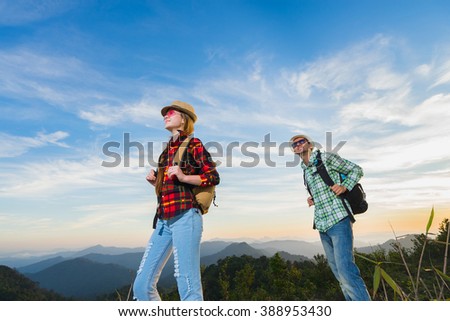 Travel concept. Hikers with backpacks walking in mountains at sunny day. 