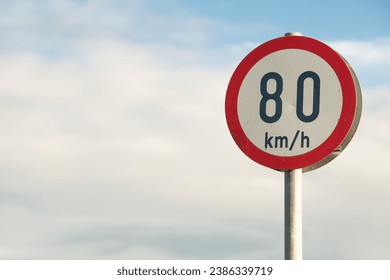 Travel concept. Information board on road. Speed limitation 80 km h sign. Close up. Text space. Outdoor shot