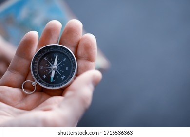 Travel concept. Magnetic compass in the hand. Retro navigator in hand map and airplane background. Adventure Background. - Powered by Shutterstock