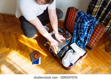 Travel Concept Man Put Stuff Suitcase Stock Photo (Edit Now) 1090597076