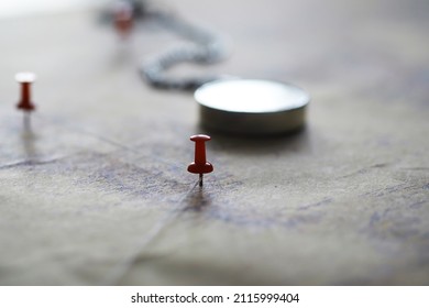 Travel Concept. Map And Needle With A Marked Place. Compass Point On Map And Routes.