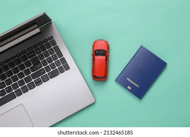 Travel Concept, Online Booking. Laptop With Car And Passport On Blue Background