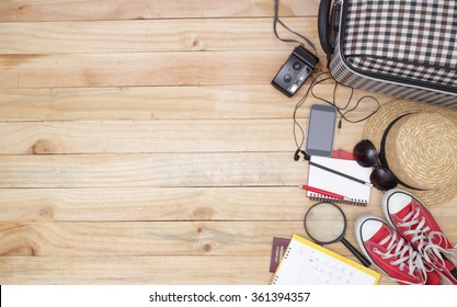 travel concept : Outfit of traveler, student, teenager, young woman or guy. Overhead of essentials for modern young person. Different objects on wooden background.