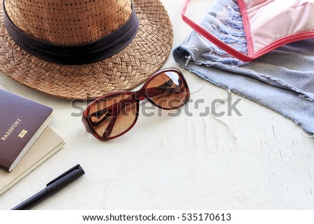 travel concept. set of women's accessories seen from above on white wood table with free text space. summer holiday. over light