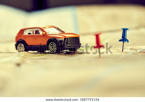 travel concept - small\
toy car on the map