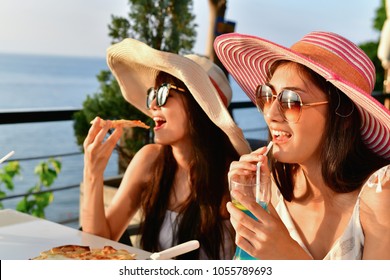 Travel Concepts. Beautiful girl is eating at a seaside restaurant. Asian girls come to relax at the beach restaurant. Asian girls enjoy eating at the beach restaurant.