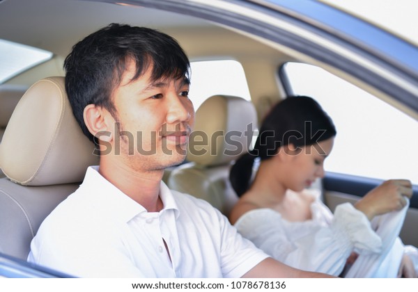 Travel Concepts.\
Family is driving on the road. Family drive safely with caution.\
Parents care baby in the\
car.