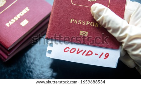 Travel and corona virus concept, a note COVID-19 in tourist passport. Medical test at border control due to COVID. World tourism hit by coronavirus, restrictions during pandemic. Immigration theme.