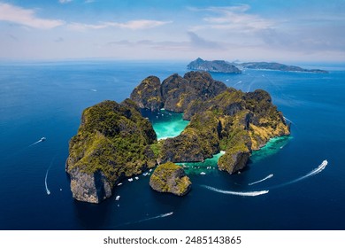 Travel drone photo of Phi Phi Leh with Maya Bay and Pileh Lagoon, Krabi province, Thailand. Aerial top view of amazing tropical island with turquoise water and white beach.