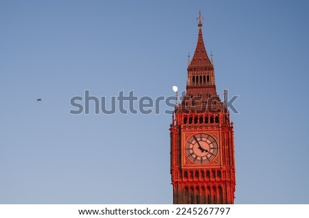 Travel to England, landmark photo. Big Ben tower clock building after renovation during a beautiful sunset with moon rising in background against clear sky. Foto d'archivio © 