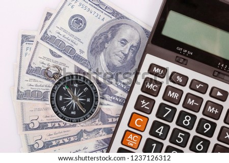 Travel & Exploration Concept : Compass Notebank and coin with Notebook and Calulator