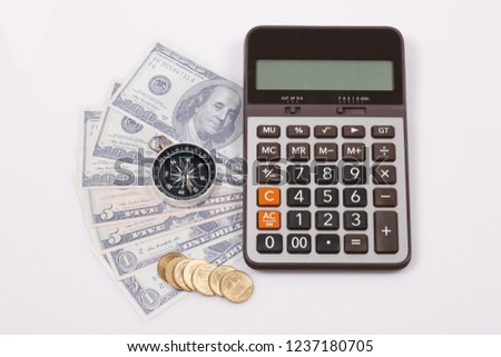 Travel & Exploration Concept : Compass Notebank and coin with Notebook and Calulator