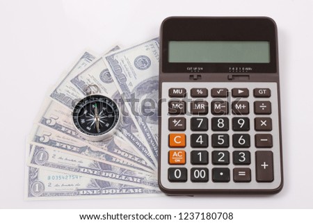 Travel & Exploration Concept : Compass Notebank and coin with Notebook and Calulator