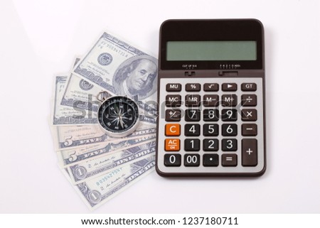 Travel & Exploration Concept : Compass Notebank and coin with Notebook and Calulator