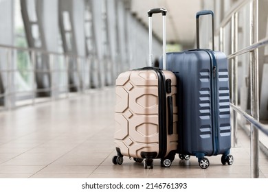 Travel Fashion. Closeup Shot Of Two Plastic Suitcases Standing At Empty Airport Corridor, Stylish Luggage Bags Waiting At Terminal Hall, Banner For Air Travelling And Vacation Booking Concept