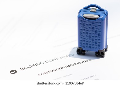 Travel And Financial Saving Concept. Miniature Baggage And Booking Confirmation Ticket.