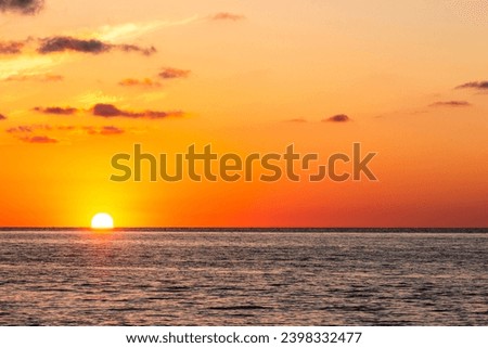 travel to Georgia - setting sun in orange sky over Black Sea water in Batumi on autumn evening