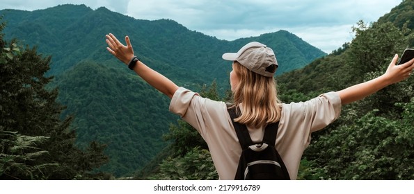 Travel. Girl travels through the mountains and waterfalls of wild nature. Unity, mental health, eco travel. Hiking in the mountains, van life vibes, travelling,good moments, digital detox - Powered by Shutterstock