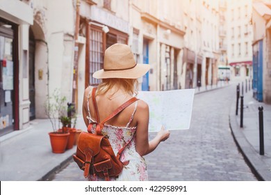 travel guide, tourism in Europe, woman tourist with map on the street - Shutterstock ID 422958991