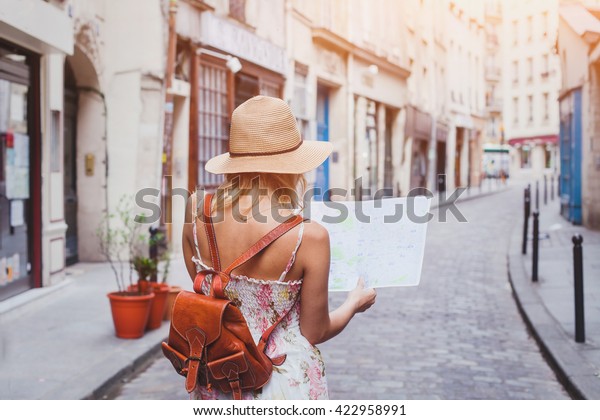 travel guide, tourism in Europe, woman tourist
with map on the street