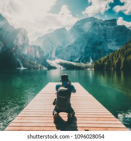 Travel hiker taking photo of Lake Braies (Lago di Braies) in Dolomites Mountains, Italy. Hiking and outdoor adventure lifestyle.