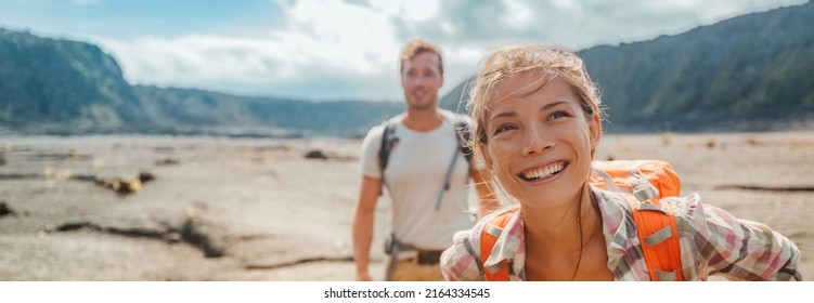 Travel hiking couple hikers happy with backpacks on summer outdoor active adventure vacation. Smiling Asian girl and man hikers banner landscape panoramic - Powered by Shutterstock