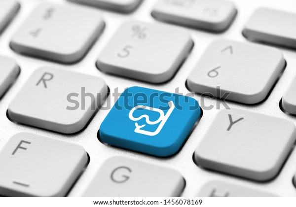 Travel icon on computer keyboard for online\
booking concept