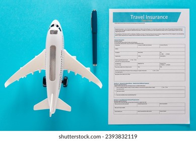 Travel insurance application form, pen and air plane model on blue background