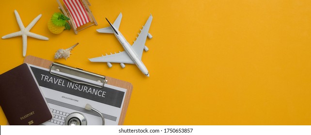 Travel insurance concept : Travel insurance form on clipboard, stethoscope, passport, decorations and copy space on yellow background 