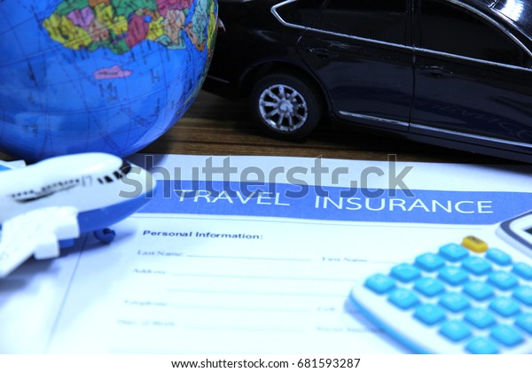 Travel insurance concept, plane model and\
car model with calculator on wooden\
table