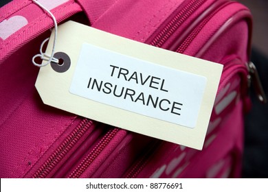 Travel Insurance label tied to a suitcase
