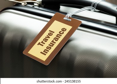 Travel Insurance Luggage Tag Tied To A Suitcase