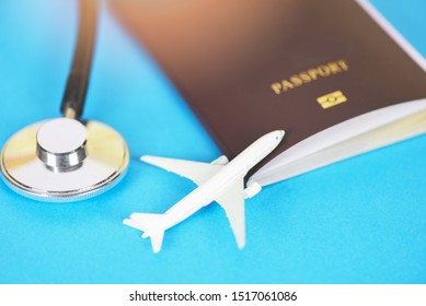 Travel Insurance With Passport And Stethoscope On Blue Background / Air Travelling For Health Or Global Healthcare Concept