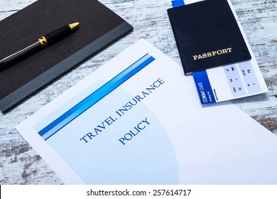 Travel insurance policy booklet with a boarding pass and a passport 