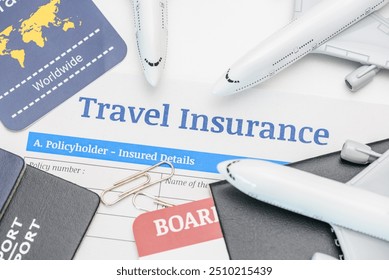 Travel insurance and service concept : Top view of travel insurance application form, a boarding pass, passport, airplanes. Travel insurance covers costs and losses associated with traveling. - Powered by Shutterstock