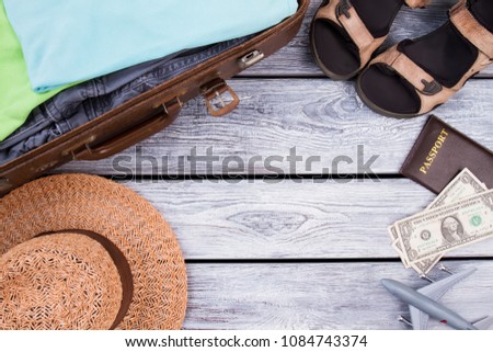 Travel items with copyspace. Flat lay, top view. Wooden desk surface background.