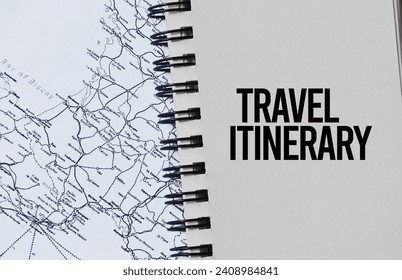 Travel itinerary word text written on notepad with black and white maps as background