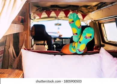 Travel Lifestyle With Minivan And Vanlife Style - Unrecognizable Girl Inside A Retro Camper - Feet With Socks Visible From A Lay Down Unrecognizable People - Happy Lifestyle Young People Journey