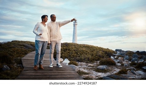 Travel, love and elderly couple pointing on boardwalk at beach, calm at a lighthouse against sunset sky. Senior, man with woman on ocean trip, holiday or vacation, happy and enjoying retirement - Powered by Shutterstock