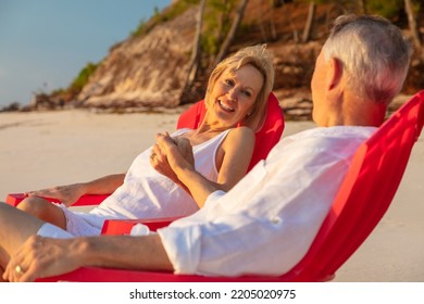 Travel Loving Retired Caucasian American Couple Smiling And Holding Hands On Tropical Beach Enjoying Romantic Island Getaway Bahamas