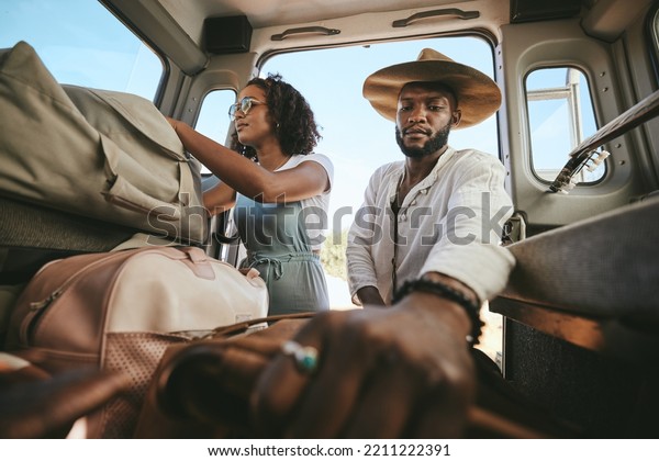 Travel luggage, black couple and car road trip\
together love bonding on nature safari holiday in Africa.\
Traveling, dating and black people, vehicle and bags for outdoor\
adventure vacation in\
Nigeria