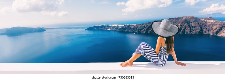Travel luxury cruise vacation holiday woman panoramic banner. Sun hat maxi dress woman relaxing at sea view in Santorini, Oia, Greece. Europe destination.