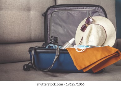 Travel. masked girl puts her things in a suitcase and dreams of rest, traveling after quarantine, blocking, covert 19. Staycation.local travel.Tourism after opening borders, end of quarantine