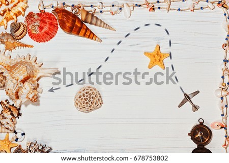Travel and nautical concept with map made of sea shells and star fish and aircraft route path top view on white background