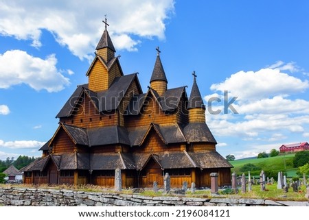 Travel to Norway in summer. Stave Church crowned with crosses. The Stave Church is crowned with crosses. The oldest and most beautiful church in Norway