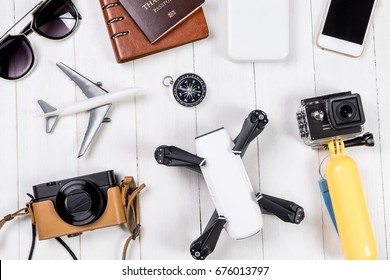 Travel objects and accessories on white wooden, Hi tech gadgets for vacation travel Vlogger and blogger Photography and video footage equipments concept.