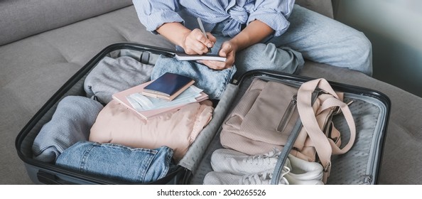 Travel. Online travel plans with Covid passport and Covid test. Traveling after quarantine, lockdown, covid 19. Staycation.local travel new normal.Girl packs baggage in suitcase and travel documents - Shutterstock ID 2040265526