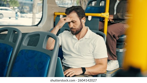Travel, passenger and man with headache, public transport and exhausted with long journey in morning. Commuting, traveller and business person with migraine in bus, burnout and stress for trip